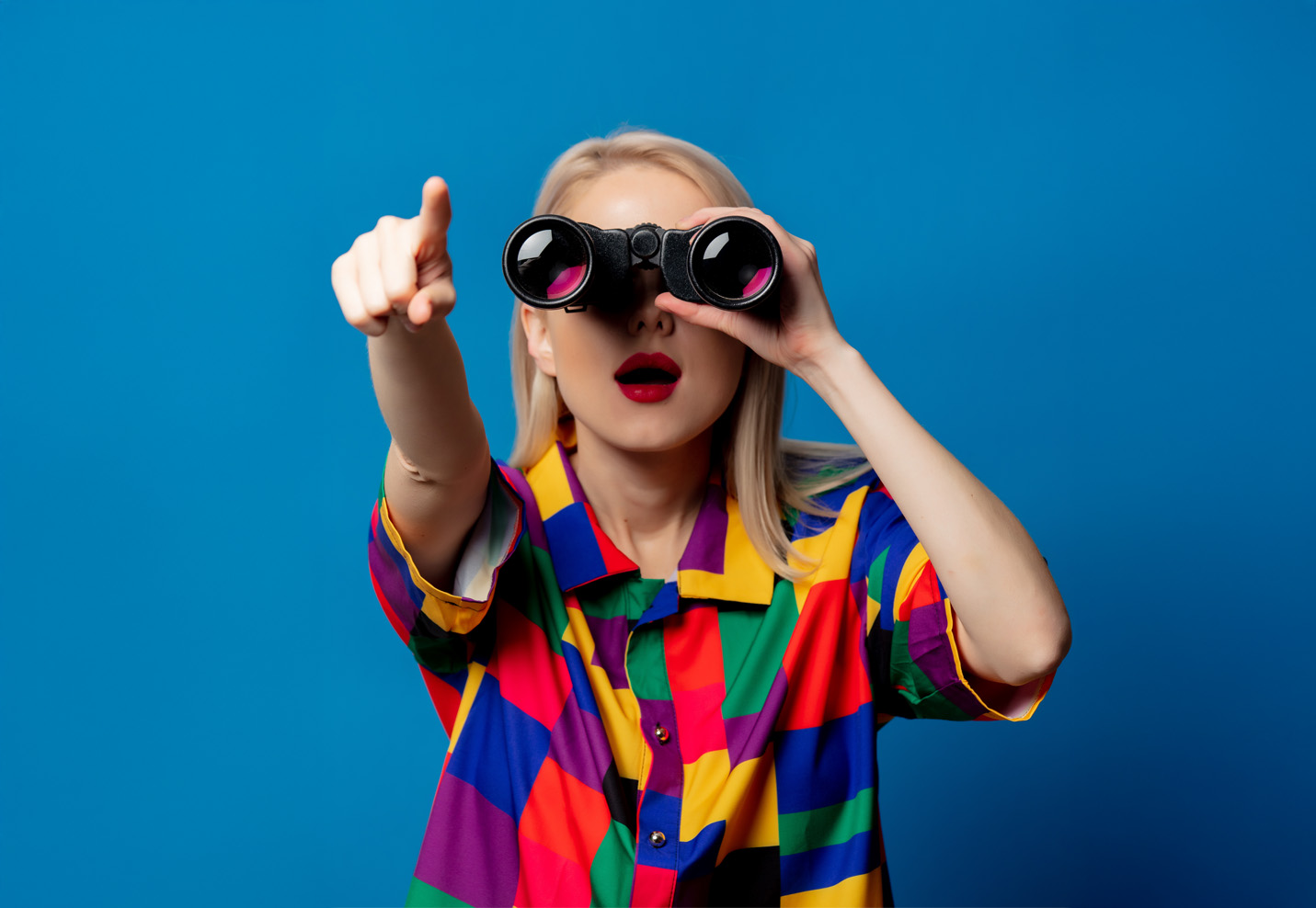 woman in red dress with binocular and laptop computer